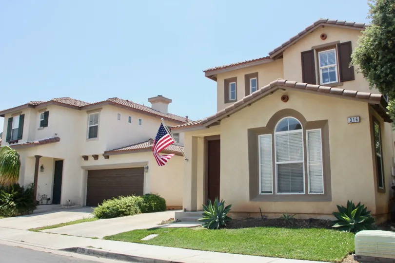 The house with model infrastructure having garage and garden with USA flag