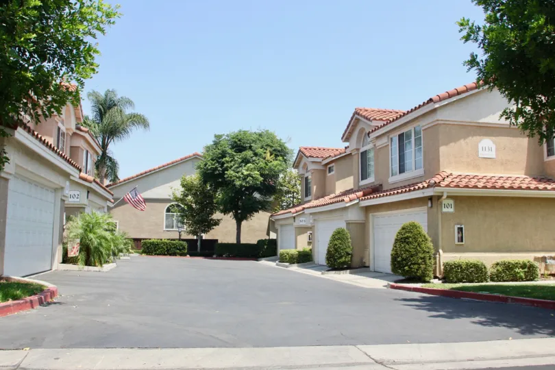 Beautiful sunny garages with nice manicured gardens at Cortina Community in Corona California