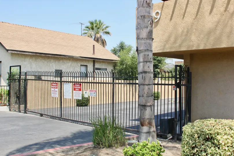 door number nine is placed on the wall of house and there is a big gate in house