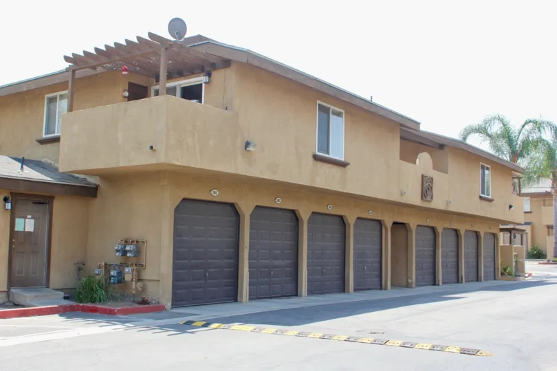 Multiple garages and palm trees but no grass at this Community