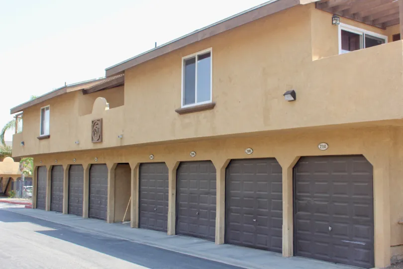 A light brown condo complex at Gianni Villas cast a shadow on the driveway.