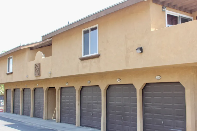 A bay of brown garage doors are on the front of the Gianni Villas.