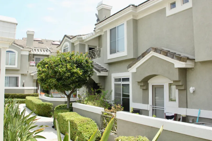 Grey is the color at these condos except for the manicured shrubbery and meticulous landscaping