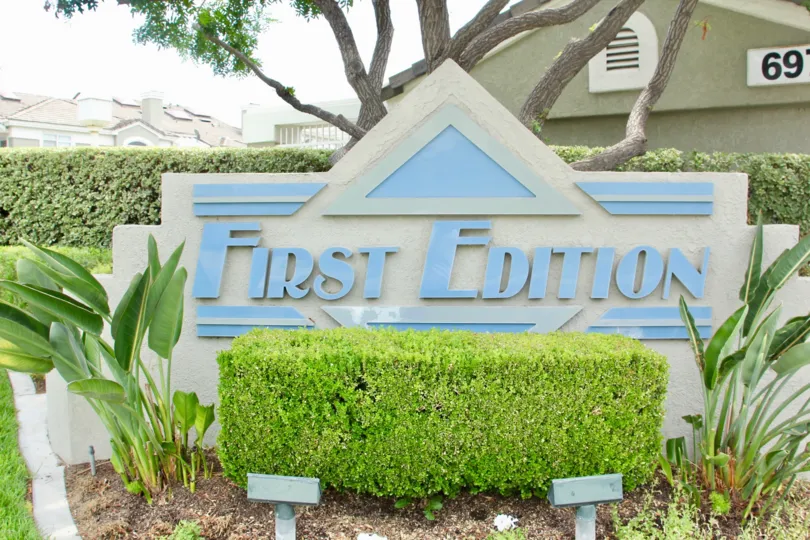 Sign of First Edition with the landscaping garden and trees