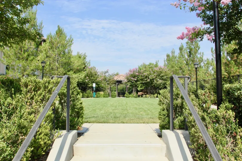 Stairs lead to a large green, yard in the Market Street community.