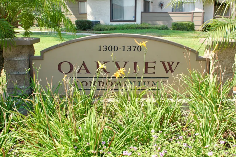 Oakview is written on a sign in a garden in Oakview community