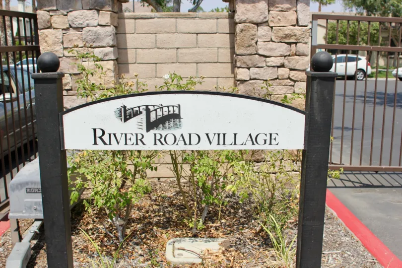 Gated entrance and sad garden at River Road Village