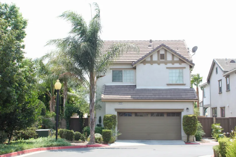 A double garage door sits on a house in the River Road Village community.