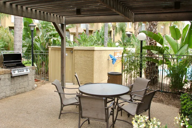 Patio with barbecue grill and patio set under pergola in Sienna community of Corona, CA.