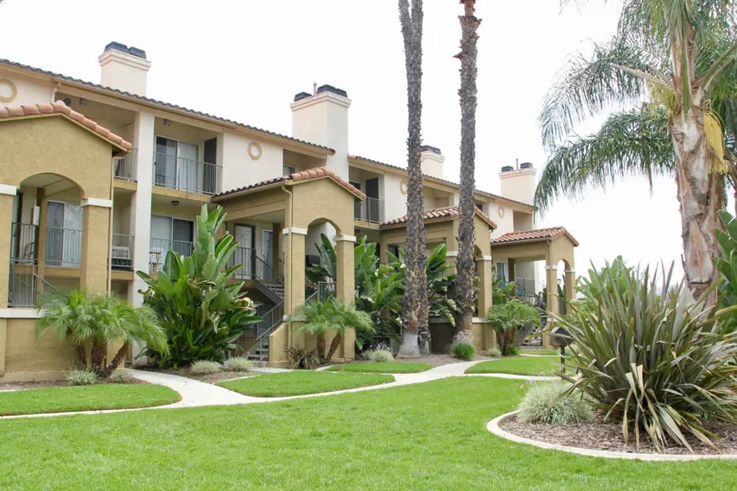 Sienna community homes with green lawn and palm trees in Corona CA