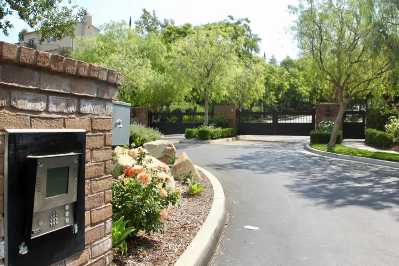 door locked machine is placd in front of house wall and near wall variety of flowers blown