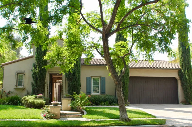 A bungalow with brownish garage doors in the Temescal Heights community.