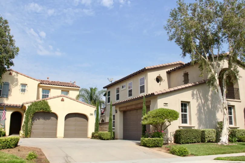 Two villas with tree beside each one in Temescal Heights community