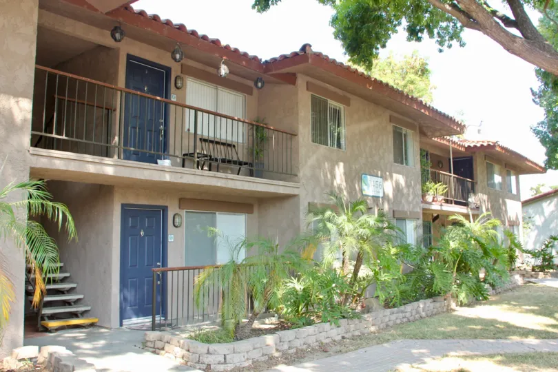 Building is nice with blue doors and palm trees at the Lakes at Corona, in Corona California