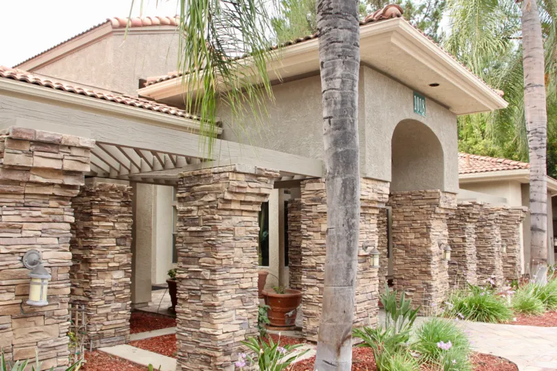 Square pillars are covered in stone at the entrance to the Triana at Corona Ranch.