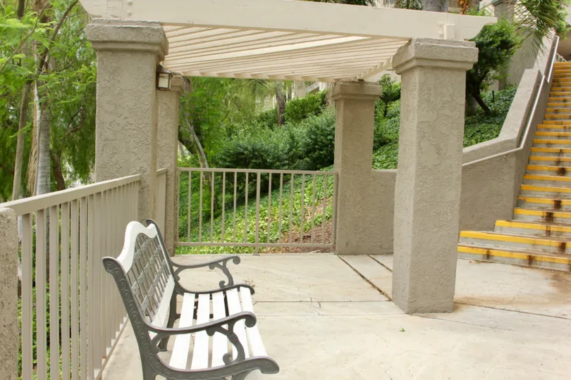 Pergola, park bench, and ascending steps at Triana at Corona Ranch in Corona, CA.