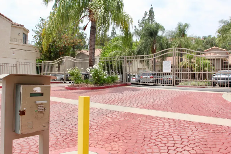 Large parking area with gated entrance and red brick flooring