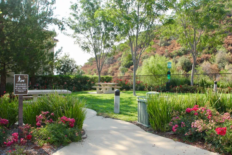 Flowering gardens adorn this dog park and picnic area in the hills of this living community