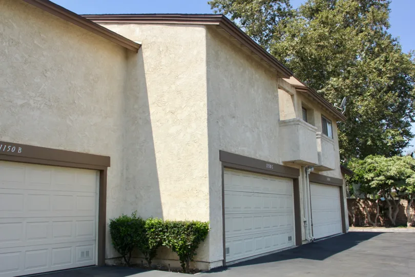 Brown trim surrounds a white garage on a building at Villa Montecito.