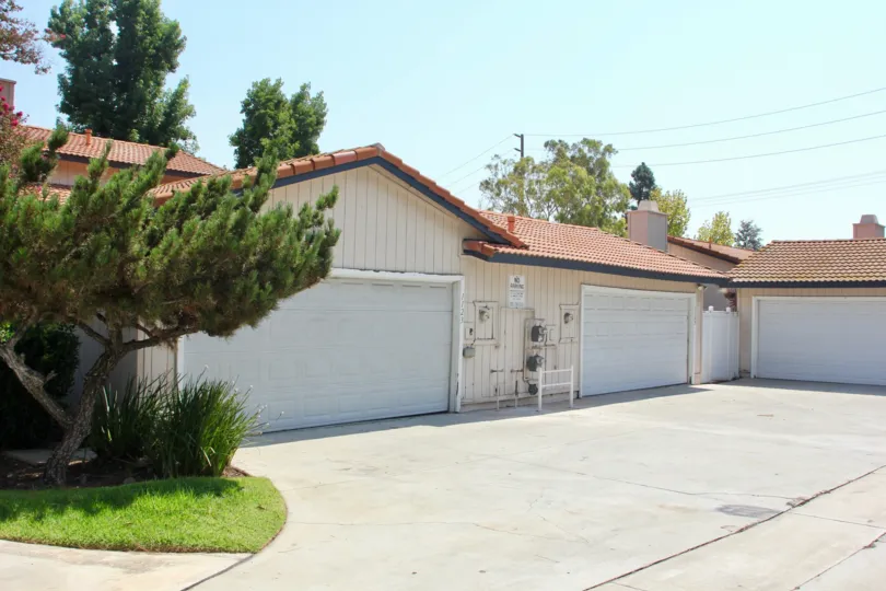 Utility boxes, and meters sit on the front of a garage at the Village Grove Cluster.
