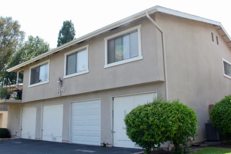 A Front place of Village Grove Four Plex with beautiful Plants and Trees