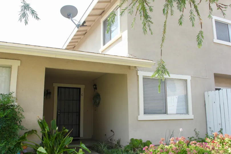 gate is placed on door and wire is hanged on wall of house and dish antenna is placed at top