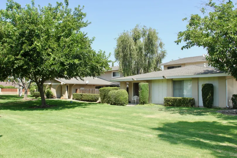 A village grove four plex in corona with full of greenery around