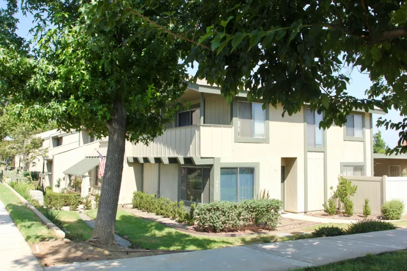 Green trim sits on a beige building in the Village Grove Townhomes.