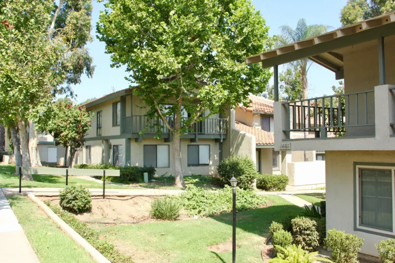 A house in the the Village Grove Townhomes where lush green trees are to be found everywhere.