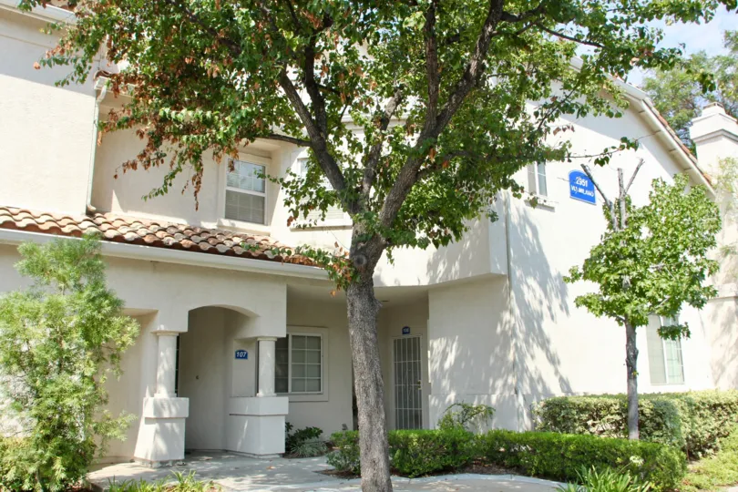 A blue sign with white lettering sits on a condo building at the Villagio.