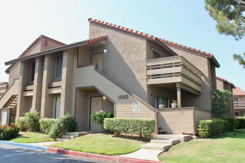 A slanted roof sits on top of a taupe like gray building at the Windwood Condos.