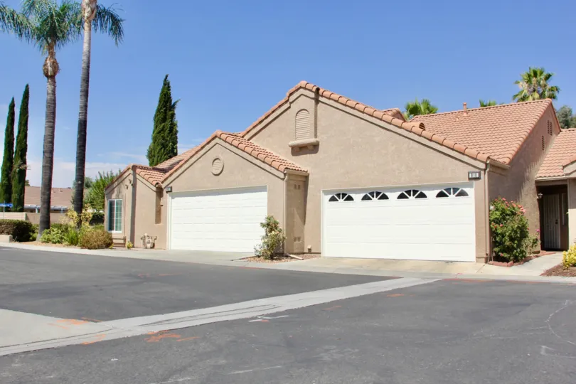 Semi-circle windows sit on a white garage door at the Terra Linda Village community.