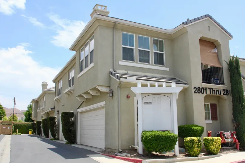 A beautiful townhouse community with parking lots and a view of the community map. It has nicely manicured greens contouring