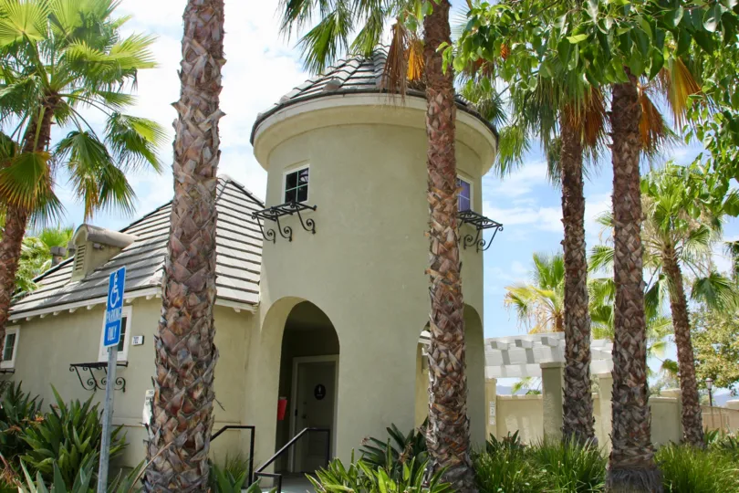 A silo-like entrance surrounded by trees in Belcaro community.