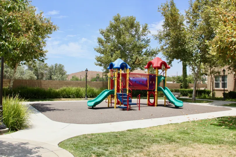 A sunny day in the Belcaro park with children's playground and picnic tables