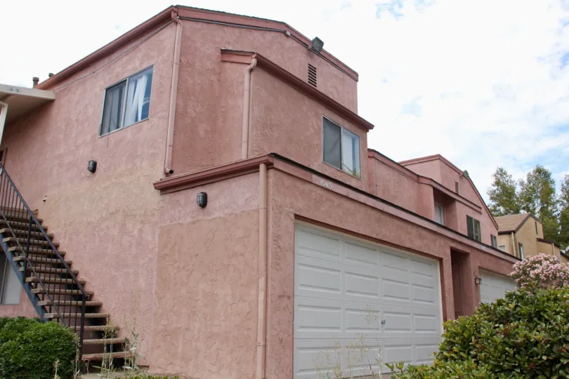 Outside view of Sycamore Landing in Lake Elsinore, California. The skies are blue and there appears to be some beautiful Lilac outside of the residence.