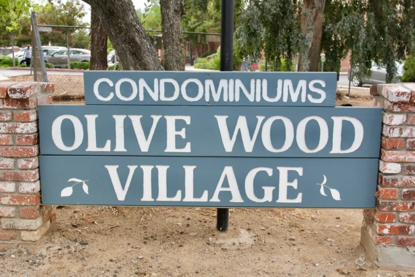 Large sign for the Olive wood Village Condominiums