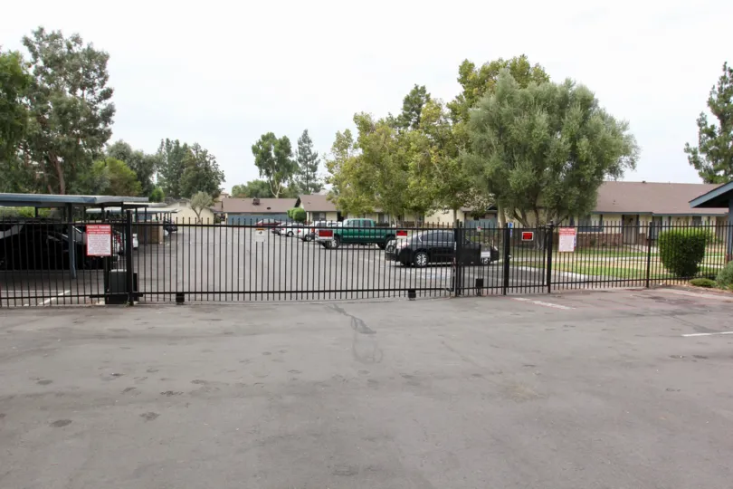Gated community lined with trees at Olivewood Village