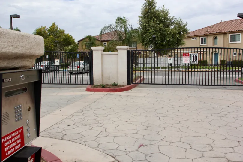 A black iron fence in front of the Palacio De Oro North community in moreno valley, CA