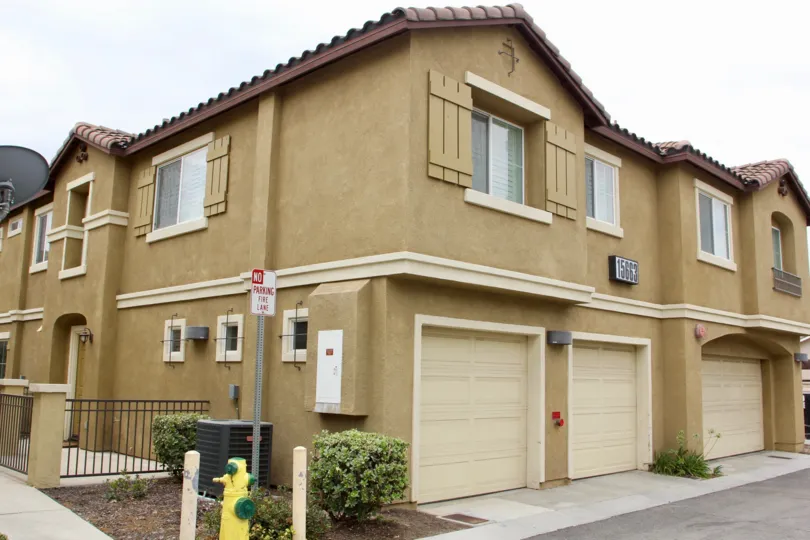 Condo with garage parking and shuttered window houses