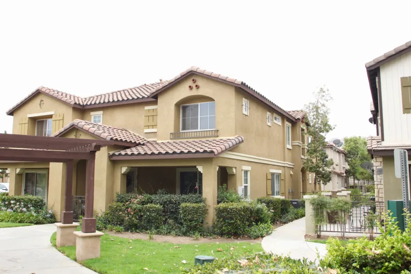 there is beautiful garden surrounded by the house with full of trees and grasses