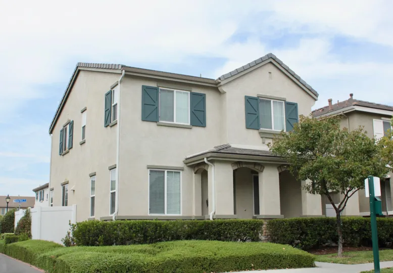 Pretty Mansions with trimmed hedges along the sidewalk at Parkside at Towngate in Moreno Valley, CA