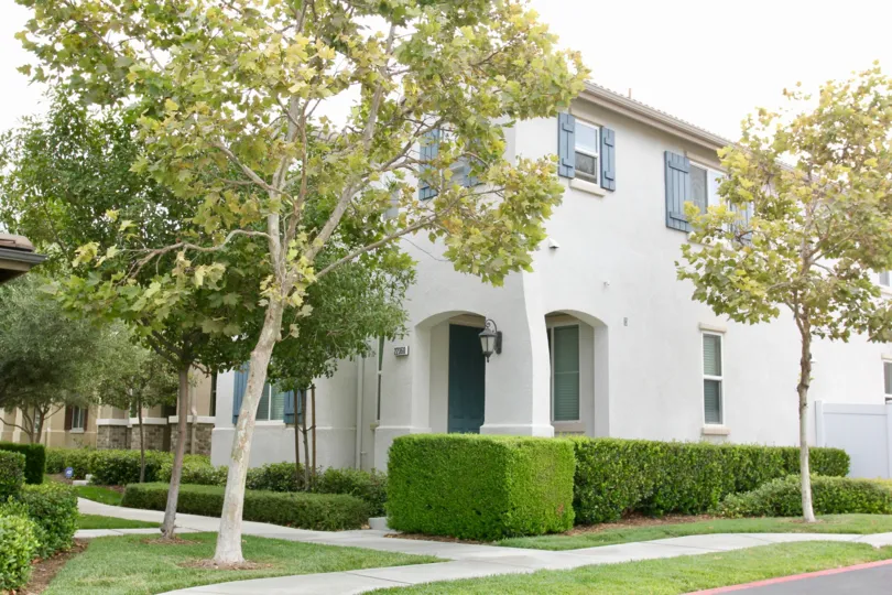 European beauty with grown in trees and trimmed privet hedges at this Parkside at Towngate condo in Moreno Valley, CA