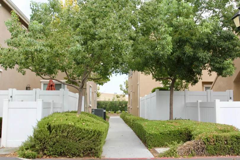 Parkside at Towngate has pretty white fences and green hedges.