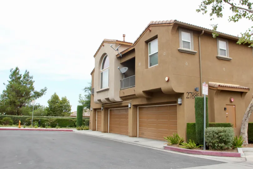 Multiple satellite dishes are festooned on tan townhomes in the Promontory Pointe community