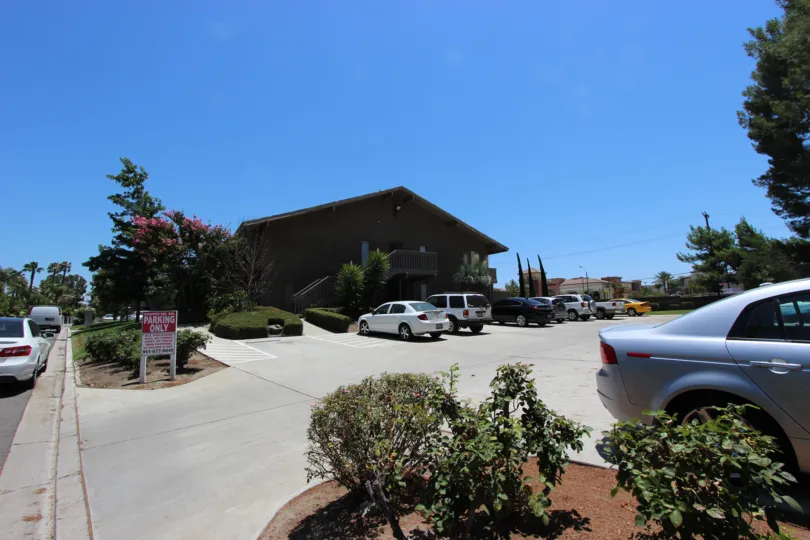 Private parking lot for residents of Casitas Del Sol entrance with landscaped shrubs
