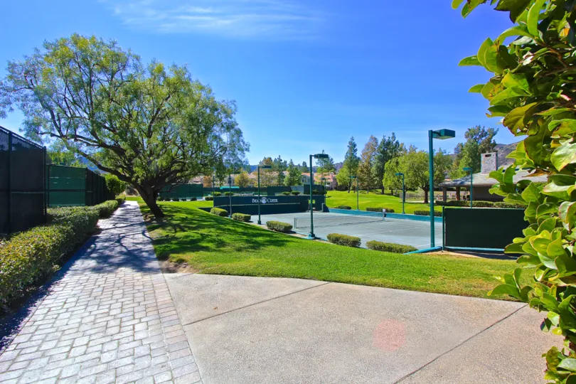 A beautiful walkway beside a tennis court in Fairway Estates at Bear Creek in Murrieta, California