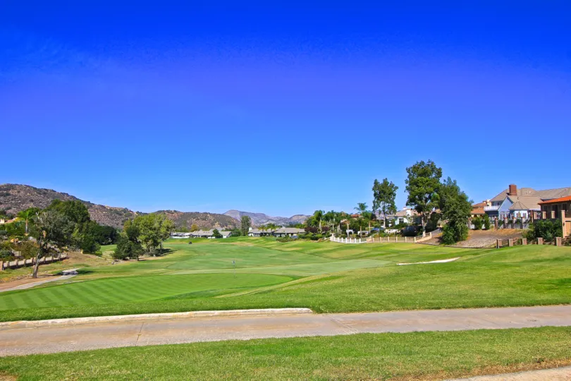 A bright, sunny day at the Fairway Estates at Bear Creek with a golf course and surrounding homes.