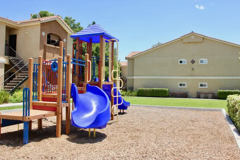 Sunny day and nice manicured gardens at the Child Playground Area in Madison Park Villas in Murrieta, California