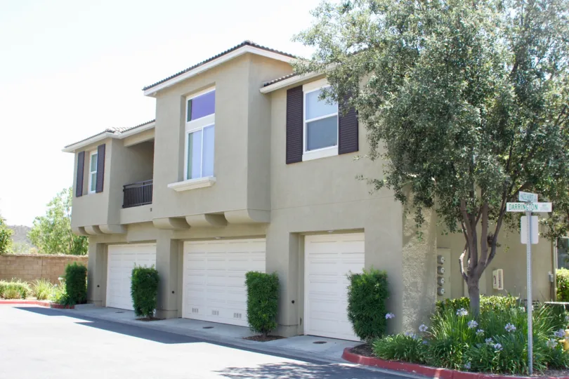North Oaks murrieta California square shaped building structure with ordered and trimmed decorative plants and tall tree